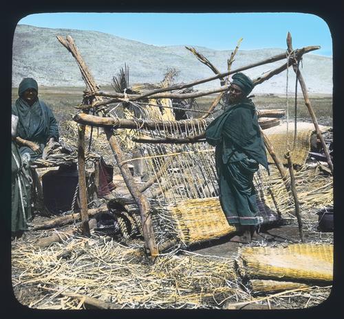 Bedouin woman weaving papyrus mats